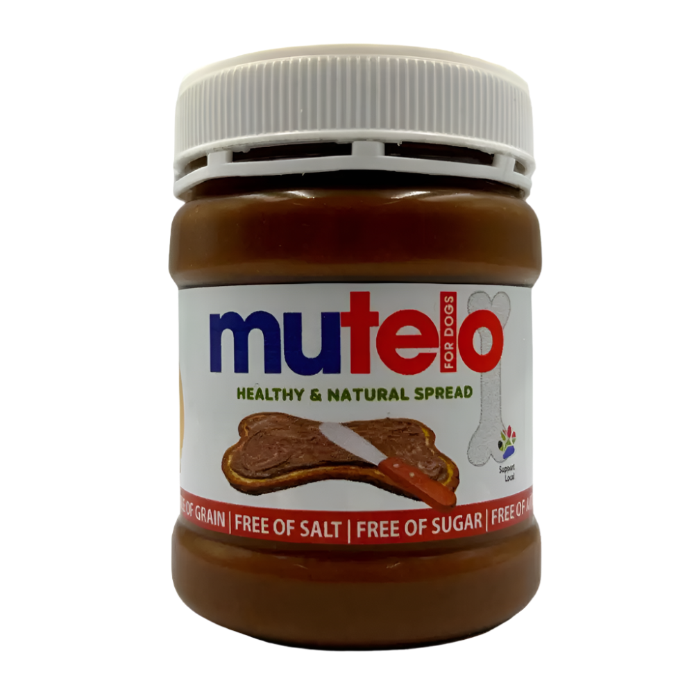 A jar of Mutelo healthy and natural spread for dogs, with the label displaying the brand name, product description, and a picture of a dog. The jar is sealed and the spread inside appears brown in color.
