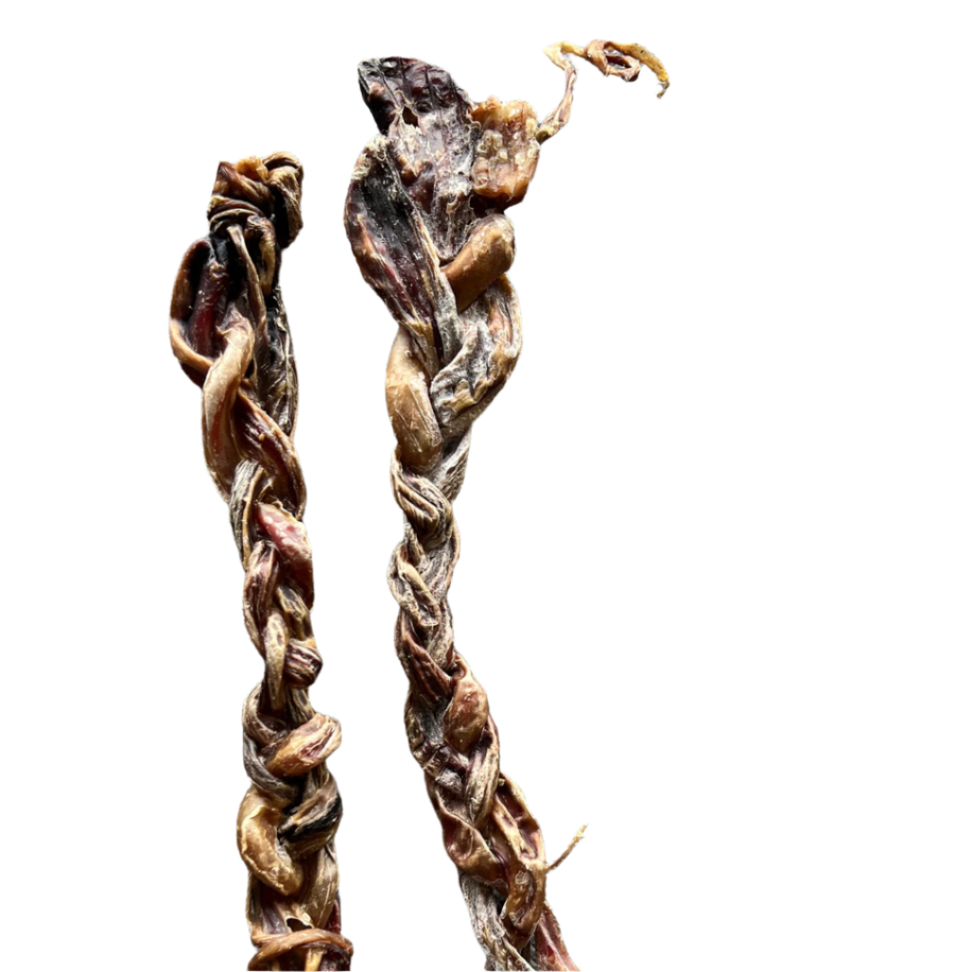 A dried pork treat, braided into a stick shape, laid on a grey surface.