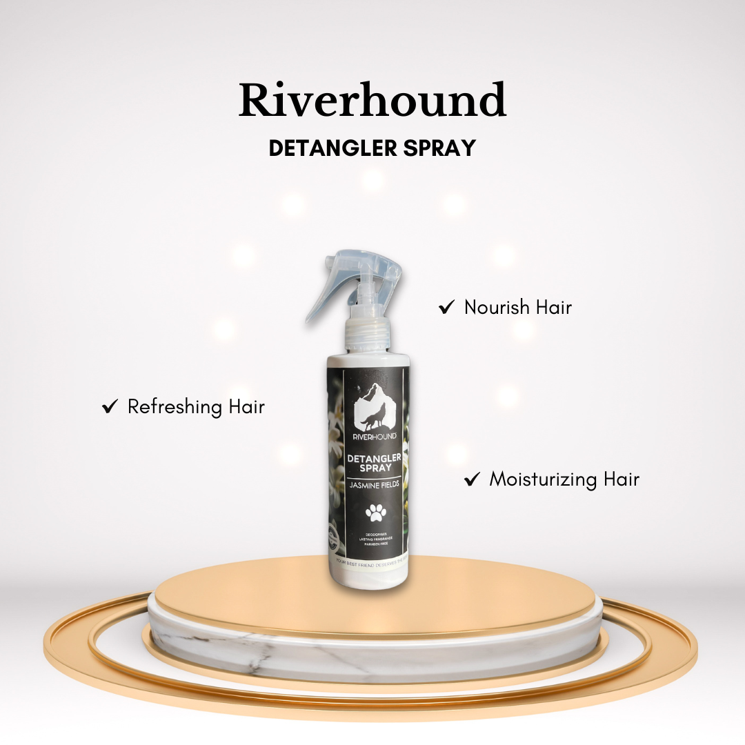 A bottle of River Hound detangler spray with a label featuring a dog and jasmine flowers, highlighting the product's nourishing hair properties and refreshing fragrance.