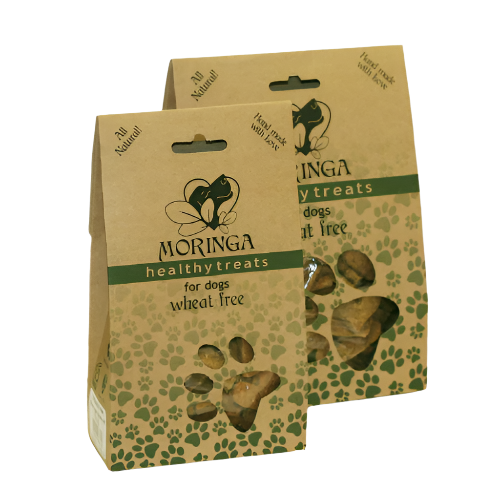 Packaging for Moringa Wheat Free Dog Treats, showing the treats visible through a window on the packaging, with brand and product information.