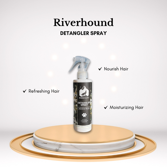 A bottle of River Hound detangler spray with a label featuring a dog and jasmine flowers, highlighting the product's nourishing hair properties and refreshing fragrance.